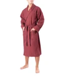 Front view of model wearing tom dick and harry burgundy polka dot dressing gown, showing pockets