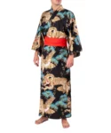 Front view of model wearing a black dragon and eagle men's yukata kimono robe with a red obi belt sash