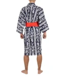 Back view of model wearing navy autumn moon happi kimono with red obi belt